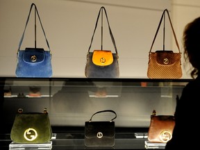 A woman looks at Gucci bags on Sept. 26, 2011 during the opening of the Gucci Museum at Palazzo della Mercanzia in Piazza della Signoria in Florence. (AFP PHOTO/TIZIANA FABI)