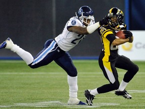Hamilton Tiger-Cats wide receiver Chris Williams is tackled by Toronto Argonauts cornerback Byron Parker during last year's pre-season game. Parker is likely to sign elsewhere when the CFL free agency window opens Wednesday. (REUTERS)