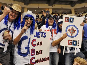 Dedicated fans cheer on their team during Winnipeg Jets' home opener vs. the Montreal Canadiens, Oct. 9, 2011. (FRED GREENSLADE/REUTERS)