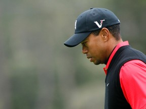 Tiger Woods reacts after missing birdie on the 13th hole during the final round of the Pebble Beach National Pro-Am in Pebble Beach, Calif., Feb. 12, 2012. (ROBERT GALBRAITH/Reuters)