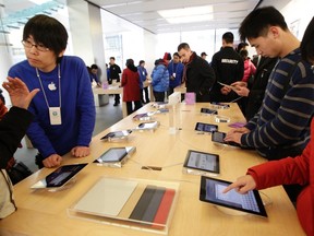 Customers test out Apple iPads in the company's flagship store in Beijing's Sanlitun Area, Feb. 15, 2012. REUTERS/Jason Lee