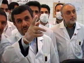 Iran's President Mahmoud Ahmadinejad watches from a control room as nuclear fuel rods are loaded into the Tehran Research Reactor in Tehran, in this still image taken from video February 15, 2012. REUTERS/IRIB Iranian TV via Reuters TV