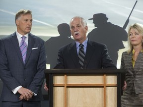 Vic Toews, Maxime Bernier and Candice Hoeppner talk about the long gun vote in Ottawa, February 15, 2012. Chris Roussakis/QMI Agency