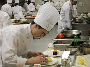 An aspiring chef at NAIT puts finishing touches on chocolate mousse.