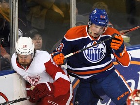 Edmonton Oilers' Ryan Nugent-Hopkins hits Detroit Red Wings' Niklas Kronwall during the first period of their NHL hockey game in Edmonton Feb. 4, 2012. (REUTERS/Dan Riedlhuber)