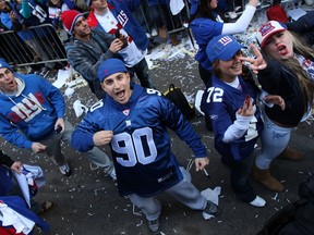 People cheer during the New York Giants' Victory Parade on Feb. 7, 2012 in New York City. The Giants defeated the New England Patriots 21-17 in Super Bowl XLVI.   (Andrew Burton/Getty Images/AFP)