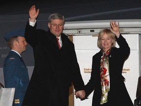 Canada's Prime Minister Stephen Harper and his wife Laureen wave while disembarking their plane after arriving in Beijing February 7, 2012. (REUTERS/Chris Wattie)
