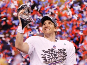 Giants quarterback Eli Manning holds the Vince Lombardi Trophy after defeating the Patriots in Super Bowl XLVI at Lucas Oil Stadium in Indianapolis, Ind., Feb. 5, 2012. (MIKE SEGAR/Reuters)