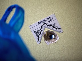 Bullet hole with forensic identification marker in the home of a west-end
Toronto family whose house was hit by a gunman Monday night. A 19-year-old woman who lives in the home was injured when the slug grazed her hand. (ROB LAMBERTI/Toronto Sun)