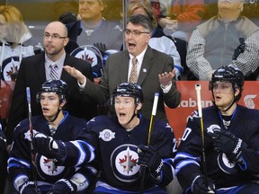 Jets coach Claude Noel and some of the players gesture toward the referees after Leafs goalie Jonas Gustavsson played the puck outside the trapezoid on a delayed penalty in the third period. The Jets thought they should have had a two-man advantage. (FRED GREENSLADE/Reuters)
