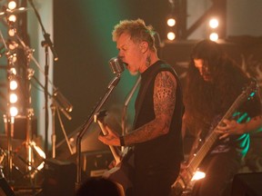 James Hetfield, U.S. lead-guitarist of the heavy-metal band 'Metallica,' performs a song with U.S. singer Lou Reed to promote their new album 'Lulu' in a Cologne TV studio November 11, 2011. (REUTERS/Wolfgang Rattay)