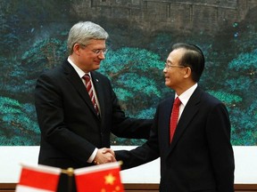 Canada's Prime Minister Stephen Harper shakes hands with China's Premier Wen Jiabao following a signing ceremony at the Great Hall of the People in Beijing February 8, 2012. (REUTERS/Chris Wattie)