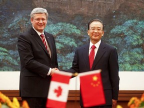 Prime Minister Stephen Harper shakes hands with Chinese Premier Wen Jiabao after their meeting at the Great Hall of the People in Beijing on February 8, 2012.  Harper is on a five-day visit to China. AFP PHOTO