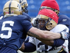 Chris Garrett (right) works out against defensive back Brady Browne during practice.
