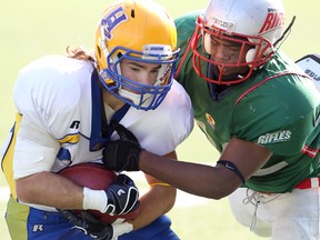 Winnipeg Rifles defensive back Abraham Eyob (r) puts the stops to Saskatoon Hilltops receiver Kyle McGinnis during Prairie Football Conference play in Winnipeg Sunday October 02, 2011.BRIAN DONOGH/WINNIPEG SUN/QMI AGENCY