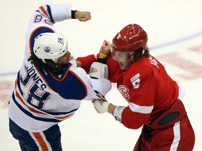Detroit Red Wings left winger Justin Abdelkader and Edmonton Oilers left winger Ryan Jones fight each other during the first period of the Wings 4-2 win in Detroit Wednesday night.