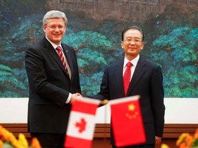 Canada's Prime Minister Stephen Harper shakes hands with Chinese Premier Wen Jiabao (R) after a signing ceremony at the Great Hall of the People in Beijing Feb. 8, 2012. (REUTERS/Diego Azubel/Pool)