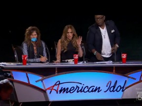 "American Idol" judges Steven Tyler (L), Jennifer Lopez (C) and Randy Jackson (R) look on as hopeful Symone Black (not seen) falls off the stage.