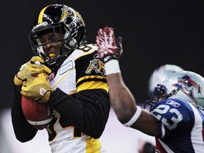 Hamilton Tiger-Cats' wide receiver Bakari Grant makes a catch in front of Montreal Alouettes' Seth Williams during their 2011 Eastern Conference semifinal. Grant re-signed with Hamilton on Thursday. (REUTERS)