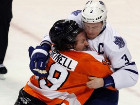 Scott Hartnell of the Flyers grapples with Dion Phaneuf after scoring the opening goal of Thursday night's game in Philly. (Reuters)