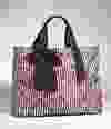 A lips-patterned nylon tote ($69.90, express.com) is grounded by black and white stripes. (Supplied)
