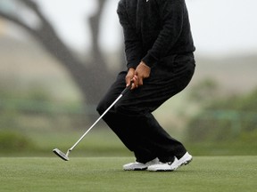 Tiger Woods reacts to a missed putt on the 14th hole during the second round of the AT&T Pebble Beach National Pro-Am on February 10, 2012 in Pebble Beach, California.  (Ezra Shaw/Getty Images/AFP)