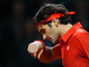 Switzerland's Roger Federer reacts during his Davis Cup tennis match against John Isner of the U.S. in Fribourg, February 10, 2012. (REUTERS/Michael Buholzer)