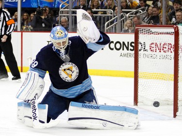 PITTSBURGH, PA - FEBRUARY 11: Marc-Andre Fleury #29 of the Pittsburgh Penguins makes a glove save against the Winnipeg Jets during the game at Consol Energy Center on February 11, 2012 in Pittsburgh, Pennsylvania. The Penguins defeated the Jets 8-5.   Justin K. Aller/Getty Images/AFP