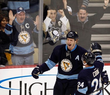 Pittsburgh Penguins Matt Cooke (24) and Jordan Staal (11) celebrate Staal's goal against the Winnipeg Jets in the third period of their NHL hockey game in Pittsburgh, Pennsylvania, February 11, 2012. REUTERS/Jason Cohn (UNITED STATES - Tags: SPORT ICE HOCKEY)