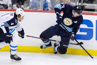Pittsburgh Penguins Evgeni Malkin (71) trips over the stick of Winnipeg Jets Zach Bogosian (4) in the second period of their NHL hockey game in Pittsburgh, Pennsylvania, February 11, 2012. REUTERS/Jason Cohn (UNITED STATES - Tags: SPORT ICE HOCKEY)
