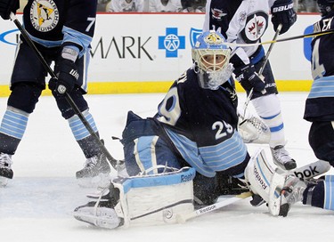 PITTSBURGH, PA - FEBRUARY 11: Marc-Andre Fleury #29 of the Pittsburgh Penguins eyes the puck in the corner against the Winnipeg Jets during the game at Consol Energy Center on February 11, 2012 in Pittsburgh, Pennsylvania.   Justin K. Aller/Getty Images/AFP