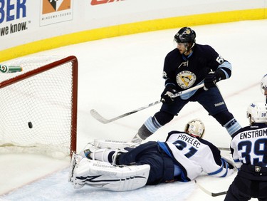 PITTSBURGH, PA - FEBRUARY 11: Kris Letang #58 of the Pittsburgh Penguins scores past Ondrej Pavelec #31 of the Winnipeg Jets during the game at Consol Energy Center on February 11, 2012 in Pittsburgh, Pennsylvania.   Justin K. Aller/Getty Images/AFP