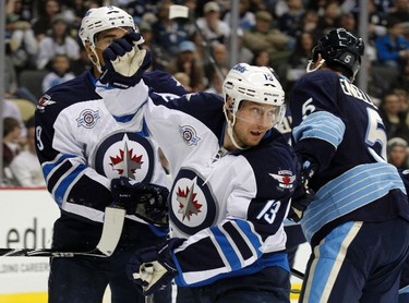 PITTSBURGH, PA - FEBRUARY 11: Kyle Wellwood #13 of the Winnipeg Jets celebrates his first period goal against the Pittsburgh Penguins during the game at Consol Energy Center on February 11, 2012 in Pittsburgh, Pennsylvania.   Justin K. Aller/Getty Images/AFP