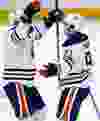 _06U5405 - February 11, 2012  - Edmonton Oilers' Ladislav Smid (5), left, celebrates Magnus Paajarvi's (91) goal during the second period against the Ottawa Senators in NHL hockey action at Scotiabank Place in Kanata Saturday, February 11, 2012.  (DARREN BROWN/QMI AGENCY)