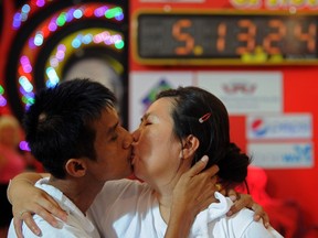 A Thai couple kisses during a competition for the "World's Longest Continuous Kiss" ahead of Valentine's Day in Pattaya on February 12, 2012. (AFP PHOTO/PORNCHAI KITTIWONGSAKUL)
