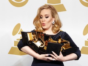 Singer Adele holds her six Grammy Awards at the 54th annual Grammy Awards in Los Angeles, California February 12, 2012. REUTERS/Lucy Nicholson