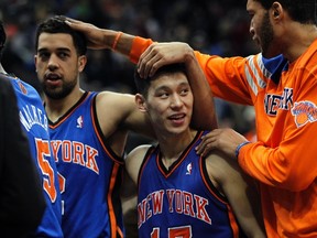 New York Knicks' guard Jeremy Lin (17) is congratulated by teammates Jerome Jordan (right) and Landry Fields after the Knicks defeated the Minnesota Timberwolves 100-98 on Sunday. (REUTERS)