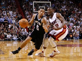 San Antonio Spurs guard Cory Joseph drives past Miami Heat point guard Norris Cole during a game last month in Miami. (REUTERS)