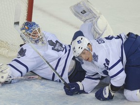 Goalie Jonas Gustavsson and Mikhail Grabovski end up in a pile as they play the Calgary Flames Tuesday night in Calgary. (STUART DRYDEN/CALGARY SUN)