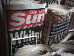 Copies of The Sun newspaper are displayed at a kiosk in London Feb. 13, 2012.  REUTERS/Finbarr O'Reilly