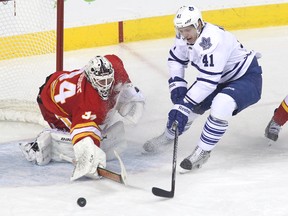 Calgary goalie Miikka Kiprusoff pokes the puck away from Leafs Nikolai Kulemin during Tuesday's 5-1 Flames win at the Saddledome. Despite losing four in a row entering Wednesday night, the Leafs still own the final playoff spot in the East. (GETTY IMAGES)