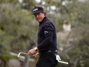 Phil Mickelson reacts after making birdie on the 14th hole during the final round of the Pebble Beach National Pro-Am in Pebble Beach, Calif., Feb. 12, 2012. (ROBERT GALBRAITH/Reuters)