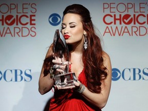 Singer Demi Lovato poses with the Favorite Pop Artist award at the 2012 People's Choice Awards in Los Angeles January 11, 2012. REUTERS/Danny Moloshok