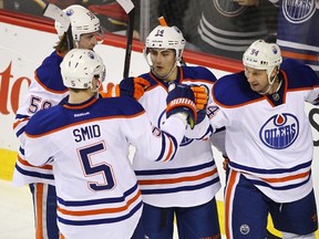 The Edmonton Oilers celebrate a second-period goal against the Flames in Calgary Tuesday, en route to a 6-1 victory. (Al Charest, QMI Agency)