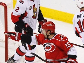 Carolina Hurricanes' Tuomo Ruutu reacts after scoring the winning goal in overtime as the Ottawa Senators' Jared Cowen looks on during their NHL hockey game in Raleigh, North Carolina Dec. 23, 2011. (REUTERS/Ellen Ozier)