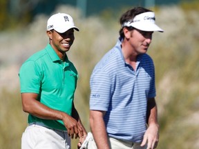 Tiger Woods (left) and Gonzalo Fernandez-Castano walk on the green of the 18th hole during the first round of the WGC-Accenture Match Play Championship in Marana, Ariz. Feb. 22, 2012. (MATT SULLIVAN/Reuters)