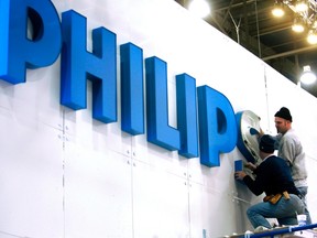 Workers put up a sign at the Philips Electronics booth before the Consumer Electronics Show (CES) at the Las Vegas Convention Center in this Jan. 3, 2008 file photo. REUTERS/Las Vegas Sun/Steve Marcus/Files
