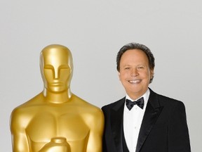 Comedian Billy Crystal, host for the 84th Academy Awards, poses in this undated publicity photograph with a large Oscar statuette. (ABC/AMPAS Handout)