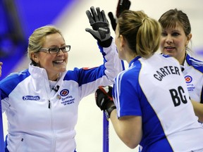 Kelly Scott, left, celebrates the win over the Manitoba crew with teammates Friday at the Scotties in Red Deer. ( Reuters)