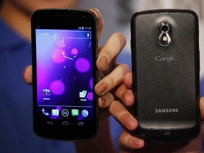 Models pose with the Galaxy Nexus, a popular Android phone, during a news conference in Hong Kong October 19, 2011.  (REUTERS/Bobby Yip)